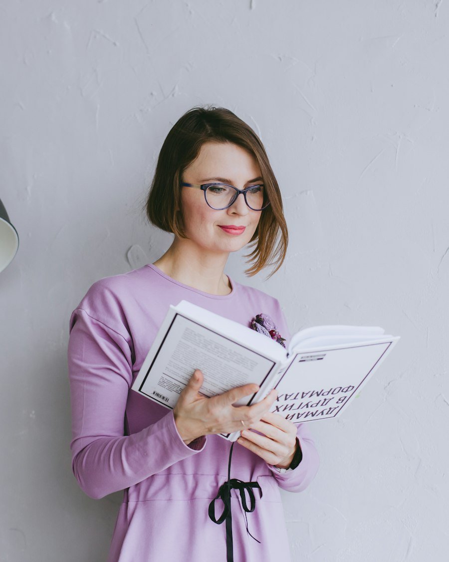 A researcher reading through papers and making notes at a desk.